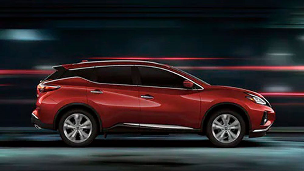 2023 Nissan Murano shown in profile driving down a street at night illustrating performance. | Horace Nissan in Farmington NM